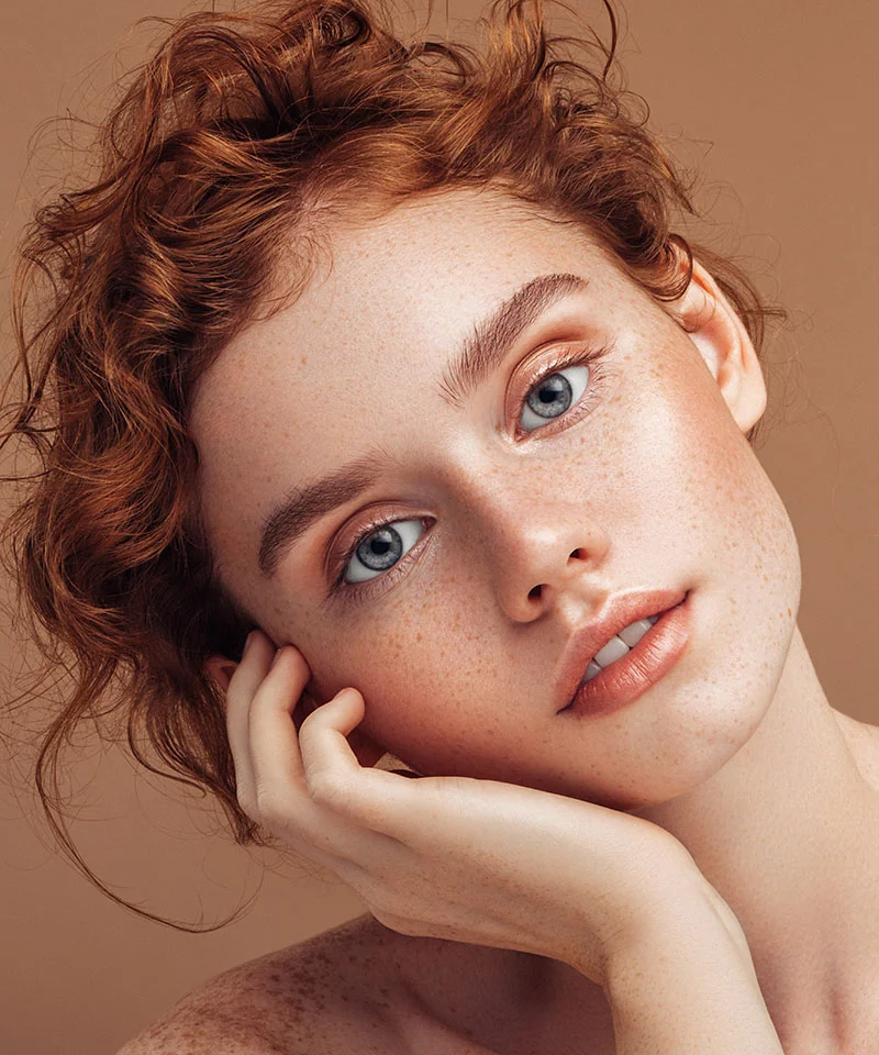 Red haired woman with blue eyes and brilliant skin close up. Dr. Costa non surgical procedures Las Vegas