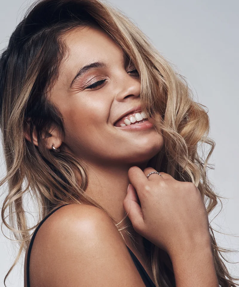Woman wrapping her face in her long hair